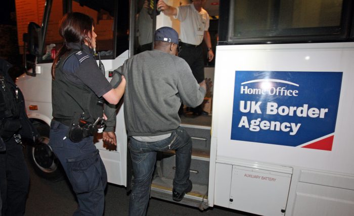 Person being escorted on to a uk border agency coach