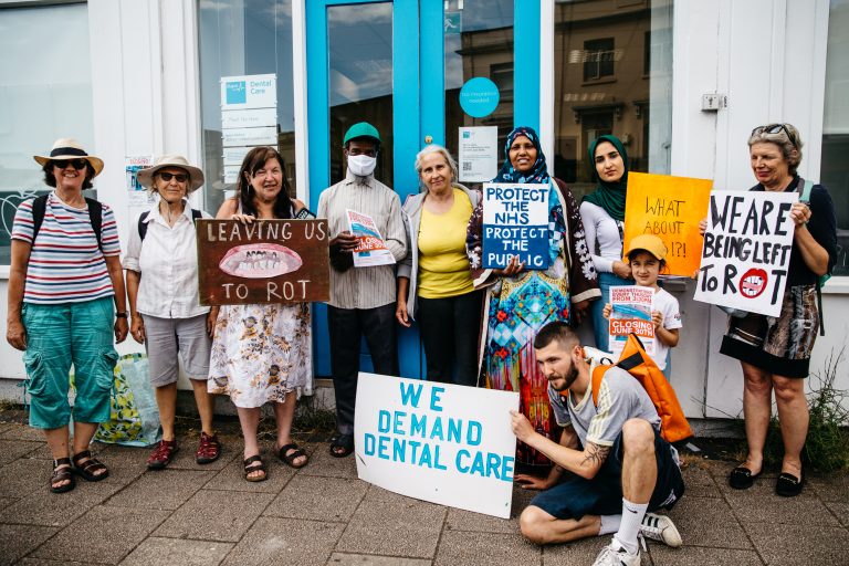 Image of campaigners with dentist Gaye Herford outside the BUPA practice in St Pauls, Bristol (credit: Alexander Turner)