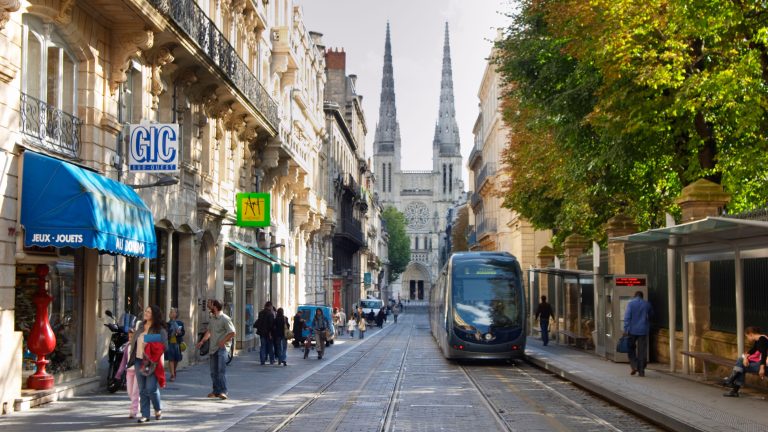 Image of a modern tram travelling along a narrow street in Bordeaux (credit: Per Karlsson / Alamy)