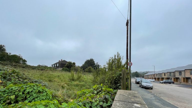 Image of derelict land awaiting transfer to Lockleaze Neighbourhood Trust sits opposite a new housing association development (credit: Alex Turner)