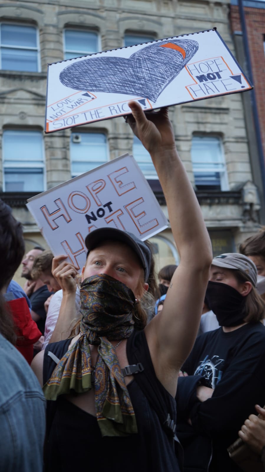 Protestors hold placards aloft, including one that says 'hope not hate'