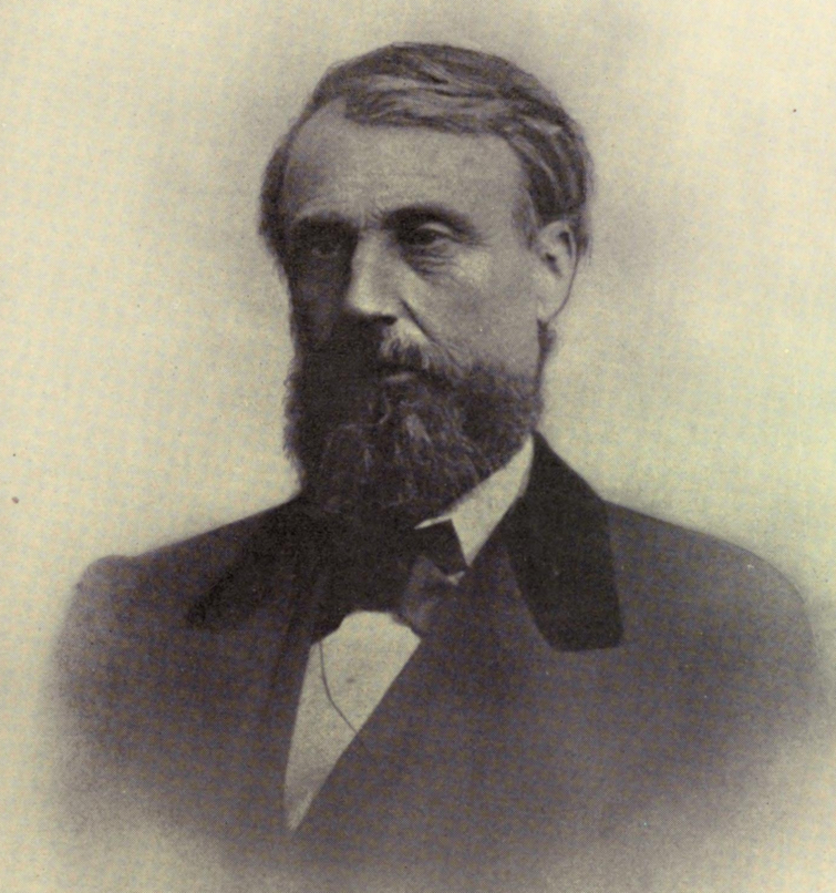 19th century photograph of a man wearing a dark suit with a black bowtie.