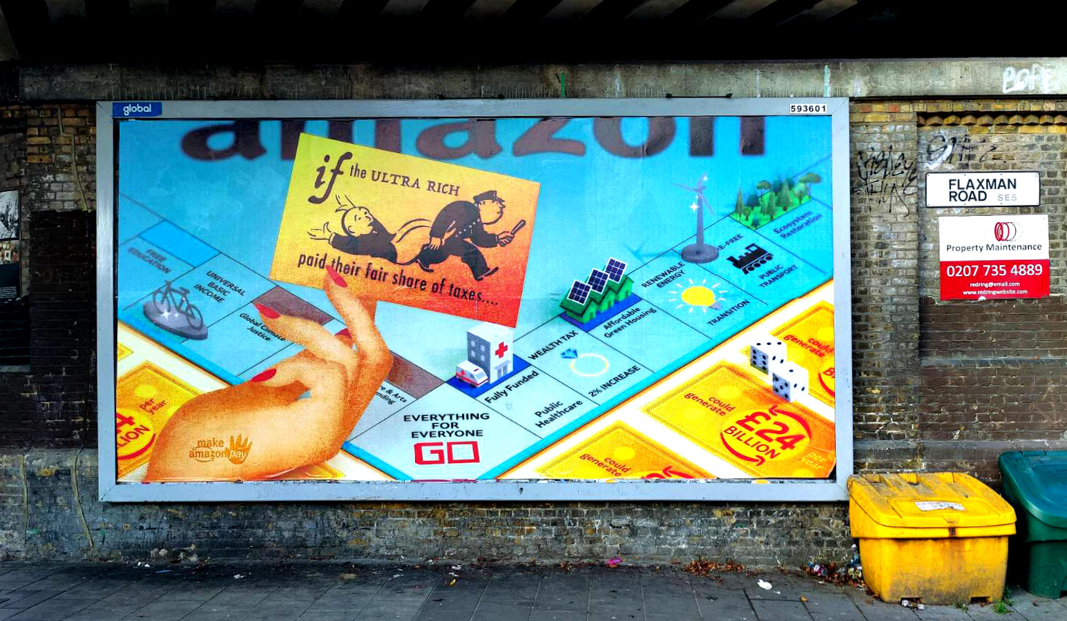 A blue and yellow billboard showing a Monopoly board on a high street wall. 