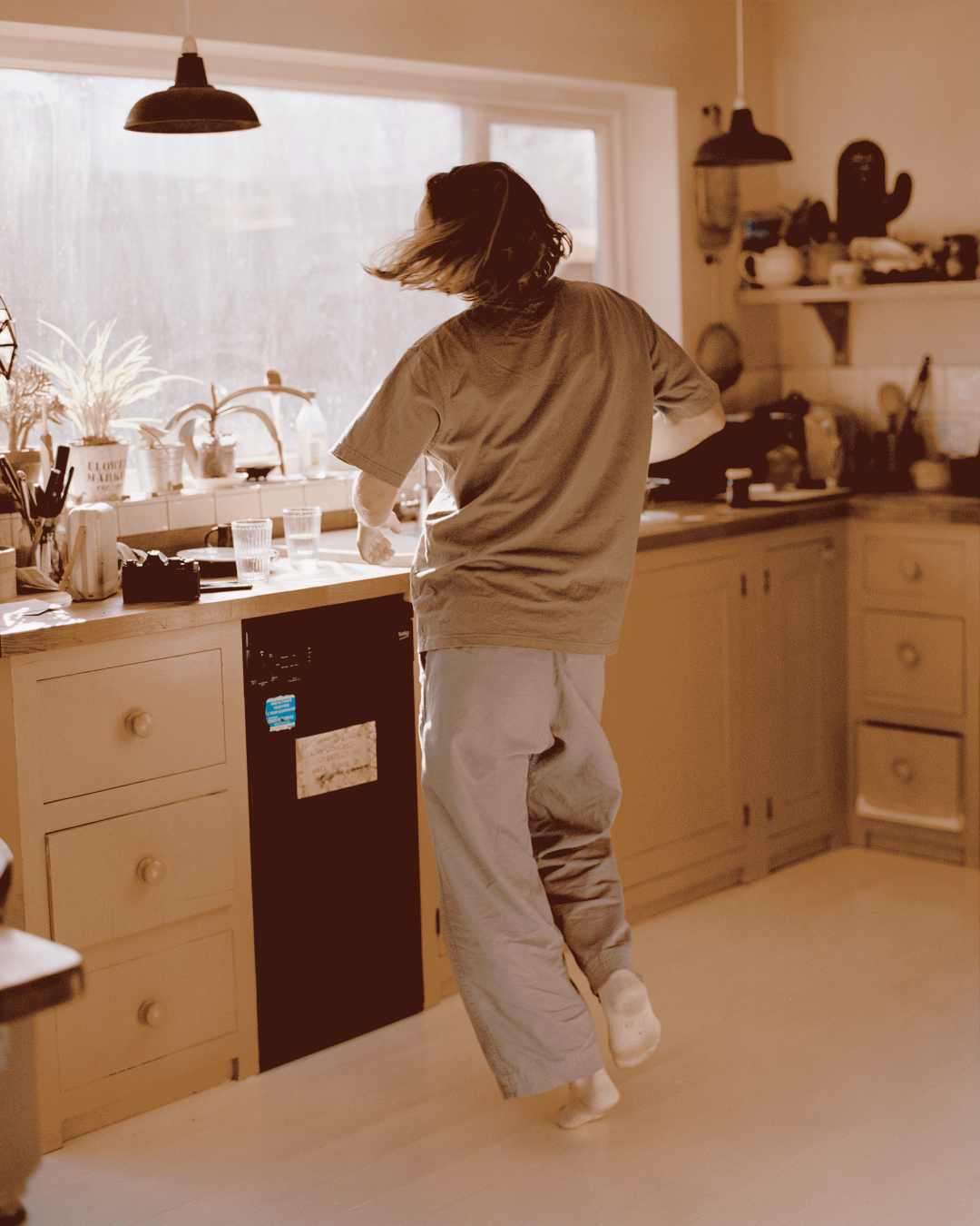 A young woman dancing in the kitchen