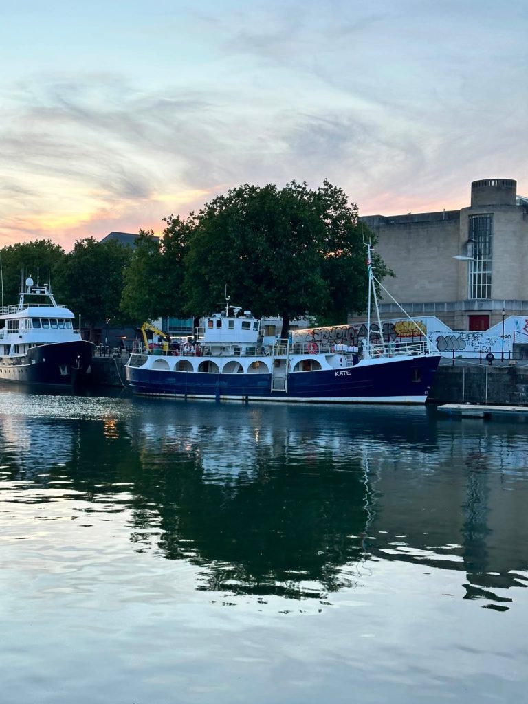 A large boat moored on a river in a city