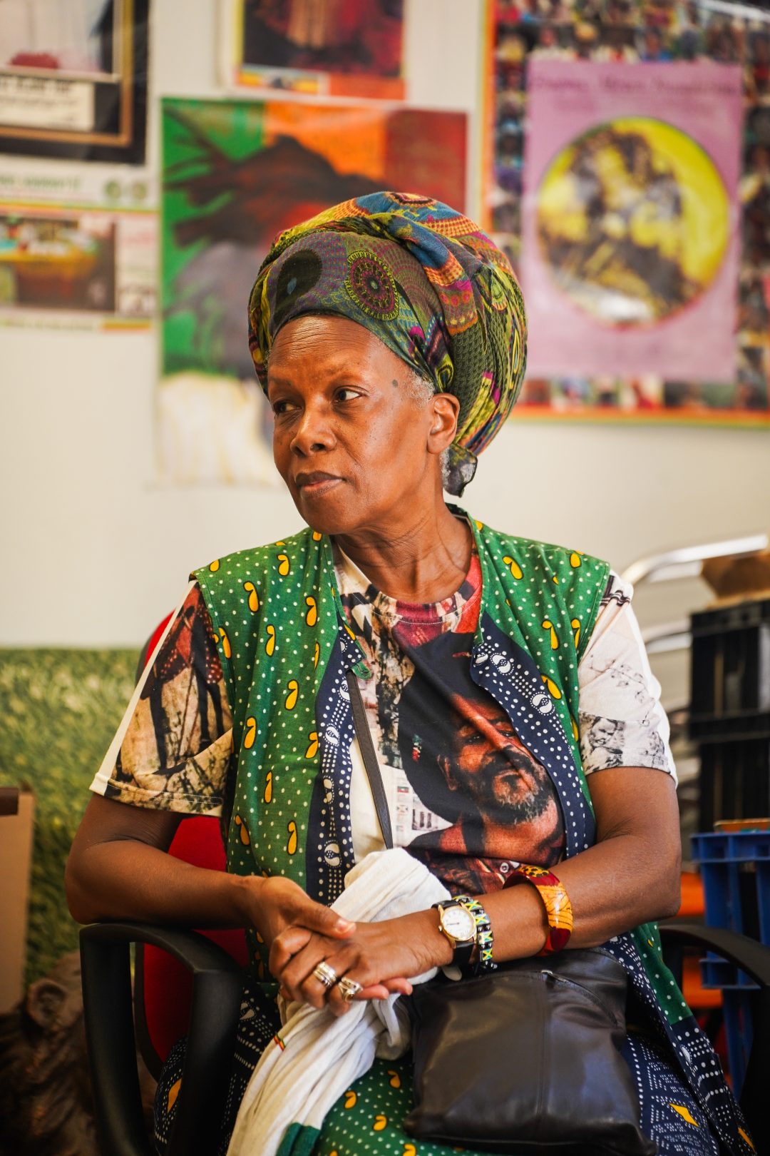 A woman in a colourful headwrap and bright clothes